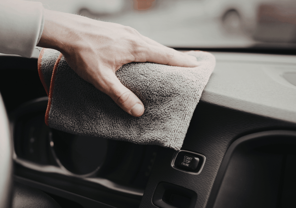 Wiping dashboard of a sedan